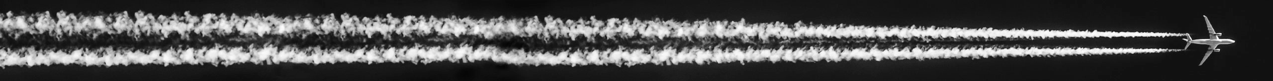 Airplane flying with trail behind it